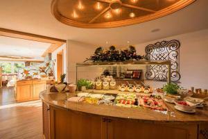 a kitchen with a buffet of food on a counter at Naturhotel Am Sonnenhang in Oy-Mittelberg