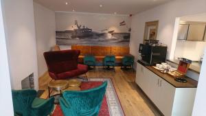 a living room with a table and chairs and a ship at Hotel De Ruyter in Vlissingen