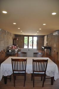 a living room with a table and chairs and a couch at Casa dos Primos in Muxagata +41 photos