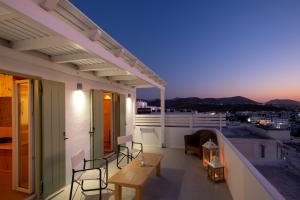a view from a balcony of a restaurant with a view of the ocean at Lorenzo Studios and Suites Paros in Naousa