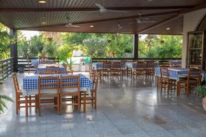 a dining room with tables and chairs in a restaurant at West End Hotel in Peyia