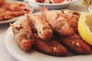 a plate of food with meat and other foods at West End Hotel in Peyia