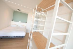 a bedroom with a bunk bed and a ladder at Ostend Studio in Ostend