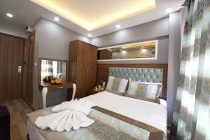 a bedroom with a large white bed with a mirror at Istanbul Sirkeci Hotel in Istanbul