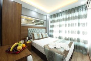 a bedroom with a bed and a tray of fruit on a table at Istanbul Sirkeci Hotel in Istanbul