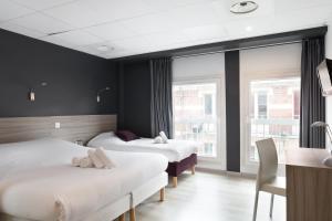Tempat tidur dalam kamar di Lille City Hotel