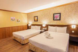 Postel nebo postele na pokoji v ubytování Kings Hotel Dalat
