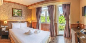 Postel nebo postele na pokoji v ubytování Kings Hotel Dalat