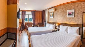 Postel nebo postele na pokoji v ubytování Kings Hotel Dalat