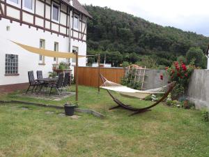 a hammock in a yard next to a house at Ferienwohnungen Eder_Ufer in Hemfurth-Edersee