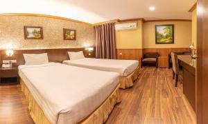 Postel nebo postele na pokoji v ubytování Kings Hotel Dalat