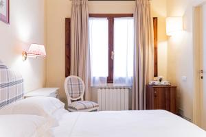 a bedroom with two beds and a window at Casa Uffizi XIII Century Tower House Boutique Hotel in Florence