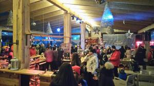 a crowd of people standing in a store at Club Rossignol in Poiana Brasov