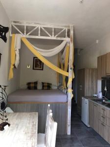 a bedroom with a bunk bed and a kitchen at Loukakia apartments in Patmos