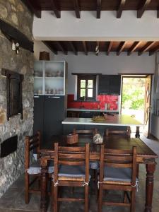 a kitchen with a large wooden table and chairs at Loukakia apartments in Patmos