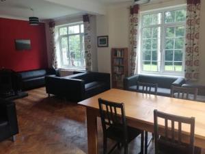 a living room with a table and chairs at Kings in Dolgellau