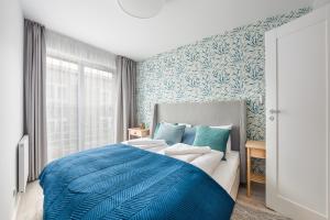 Posteľ alebo postele v izbe v ubytovaní Apartamenty Sun & Snow Residence II Jastrzębia Góra - plac zabaw, blisko plaży, wysoki standard