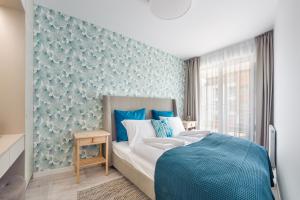 Posteľ alebo postele v izbe v ubytovaní Apartamenty Sun & Snow Residence II Jastrzębia Góra - plac zabaw, blisko plaży, wysoki standard