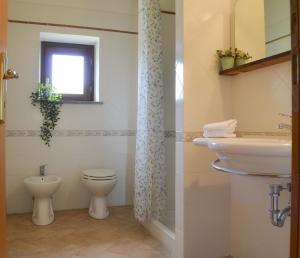 a bathroom with a sink and a toilet and a window at Caratteristico appartamento nel cuore della Tuscia in Vetralla
