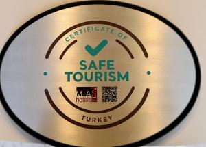 a close up of a metal disc with aire tourism sign at Mia City Hotel in Izmir