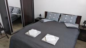 a bedroom with a bed with two towels on it at Fly Up Home apartment in Boryspilʼ