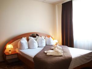 a hotel room with a bed with a towel on it at Готель "МОТОР" in Luts'k +22 photos