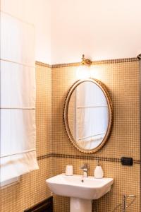 a bathroom with a sink and a mirror at Palazzo Chiara in Cagliari