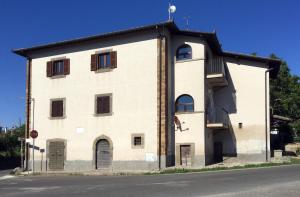 a large white building with windows and a roof at Caratteristico appartamento nel cuore della Tuscia in Vetralla