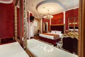 a bedroom with a bed and a mirror at De Paris Hotel in Kyiv