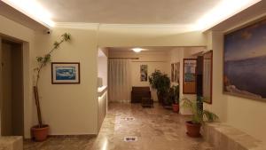 a hallway with potted plants in a building at Luis Apartments in Mastichari