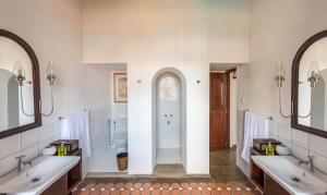 a bathroom with two sinks and a shower at Nyne Hotels - The Muse, Bentota in Bentota