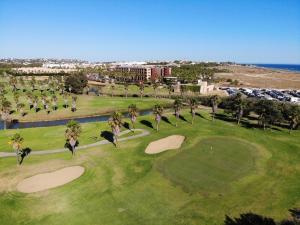 an aerial view of a golf course with palm trees at Ambassador Salgados Beach Suites in Albufeira