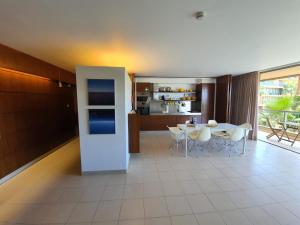 a kitchen and dining room with a table and chairs at Ambassador Salgados Beach Suites in Albufeira