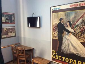 a large movie poster on a wall in a room at Vacanze Romane 2 in Rome