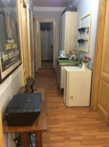 a hallway of a kitchen with a table and a laptop at Vacanze Romane 2 in Rome