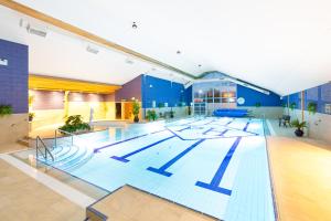
a swimming pool with a blue floor and blue walls at The Park Hotel, Holiday Homes & Leisure Centre in Dungarvan
