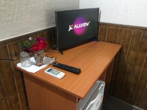 a desk with a computer monitor and a keyboard at Casa Radu in Tulcea