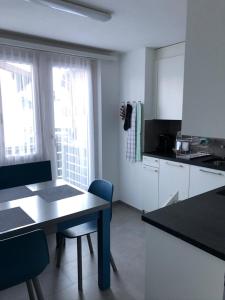 a kitchen with a table and chairs in a room at Chalet Wanda in Saas-Fee