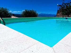 a large swimming pool with a blue pool at Villa Verde in Cefalù
