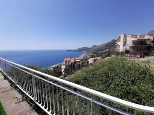 a view of the ocean from a balcony at Casa Yuliya in Letojanni