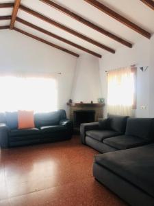 a living room with two couches and a fireplace at Los Viejitos en Firgas in Firgas