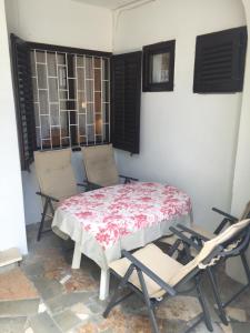 a table and chairs in a room with a table and chairs at Tisno Sea View apartment in Tisno +6 photos