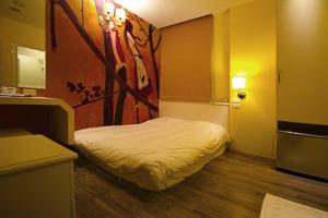 Postel nebo postele na pokoji v ubytování 澎湖寶島時尚別館 Bao Dao B&B + 3 fotografie