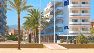 a beach with palm trees and palm trees at Hotel RH Riviera - Adults Only in Gandía