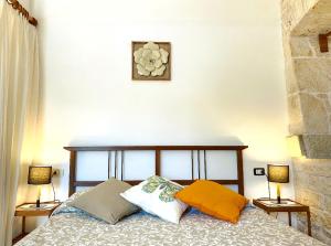 a bedroom with a bed with two pillows on it at Trulli Panoramici in Alberobello