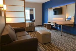 a hotel room with a bed and a desk at Microtel Inn & Suites by Wyndham Fountain North in Fountain