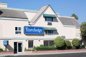 a travelodge sign on the side of a building at Travelodge by Wyndham Ocean Front in Sunset Beach