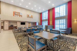 a conference room with tables and chairs and windows at La Quinta by Wyndham Aberdeen-APG in Aberdeen
