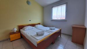 a bedroom with a bed with two pillows on it at Villa Doris YourCroatiaHoliday in Premantura