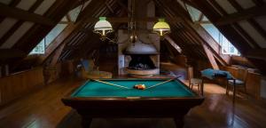 a pool table in a room with a fireplace at Le Clos Cathala Chambres d'Hôtes in Saint-Paul-de-Jarrat